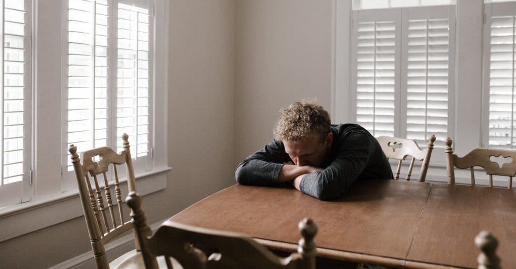 This picture shows a man experiencing anxiety, which can be treated by using CBD.